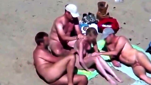 Beautiful blonde gets groped on a nude beach