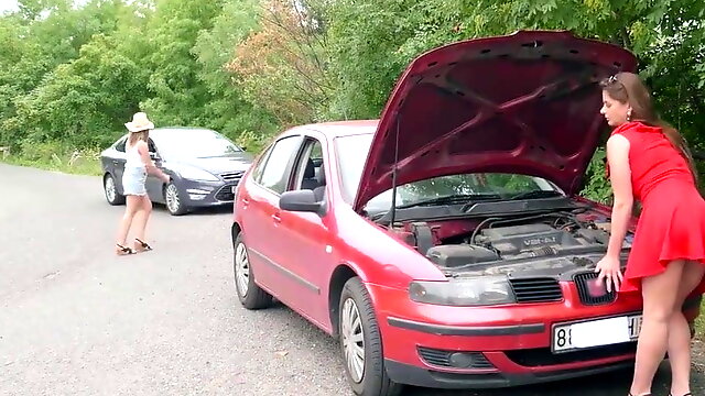 Two blondes have a broken car