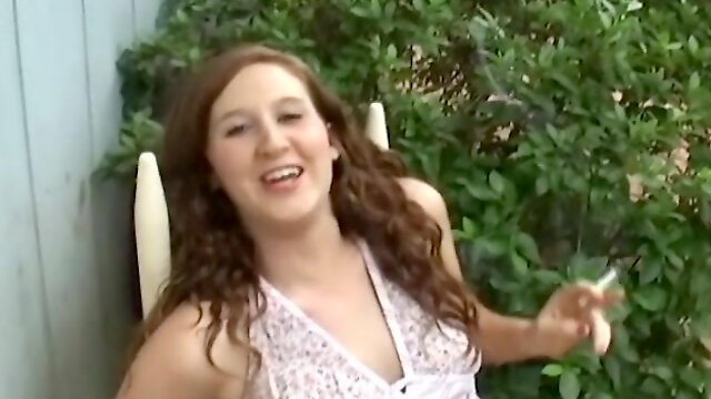 Cigarette smoking teen has lots to say as she relaxes outdoors