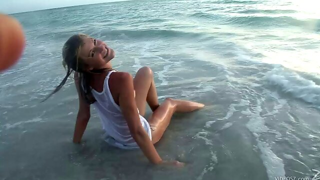 Amateur blonde teen naively poses in Wet T-shirt on the beach