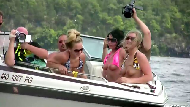 Nasty amateur girls sitting in a boat flash their boobs
