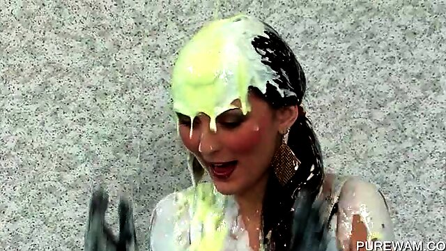 Fancy clothed lesbos get messy with paint in a pool