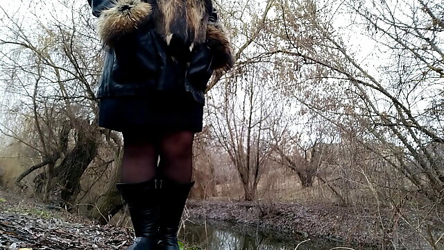 Milf in boots and a skirt peeing while standing outside