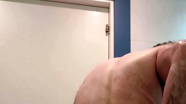 Hairy chastity bear takes a shower 