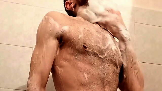 Guy washes himself in the shower and cums