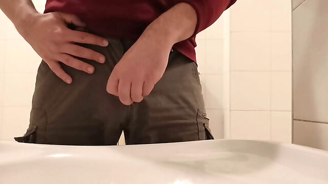 Pissing in a public toilet sink