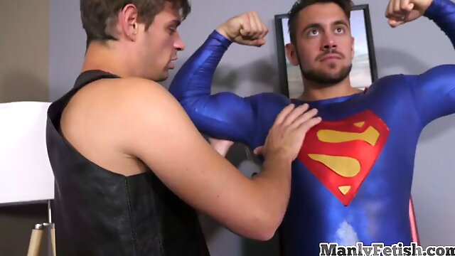 Superman jerks cock while getting pumped by erotic couple
