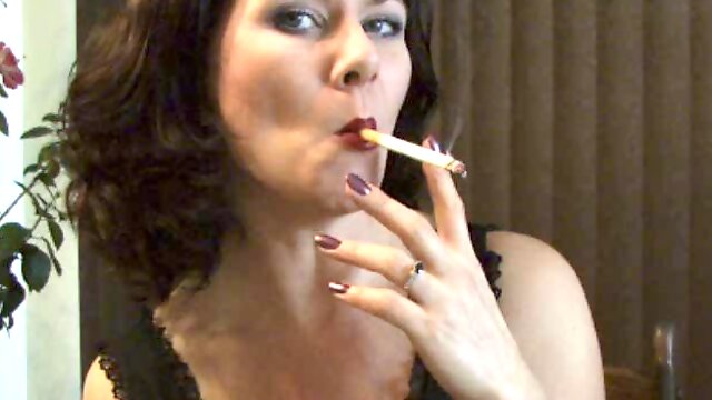 MILF Mina puffs on a cigarette