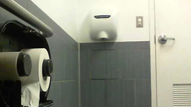 Voyeur shot of several women pissing in the public toilet