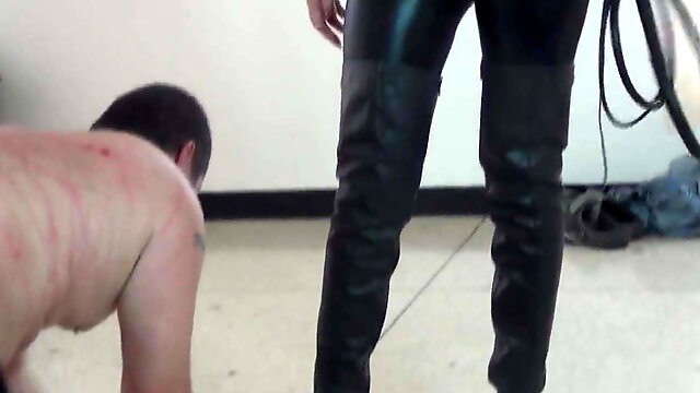 Goddess in latex boots whipping