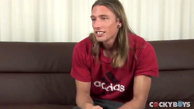 Long haired pretty boy jerking his dick on a couch