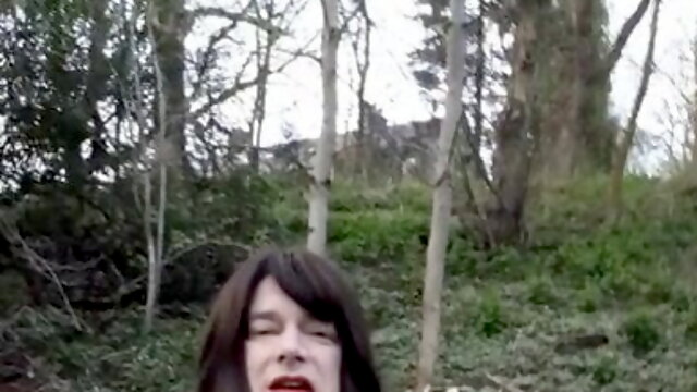 Crossdresser wearing a short leather skirt walking in the park in Waterfoot Lancashire