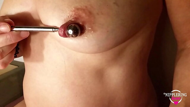 Nippleringlover horny milf inserting 16mm metal beads in extreme stretched nipple piercings