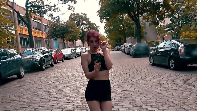 Exhibitionistic redhead girl is sucking a hard cock on the street