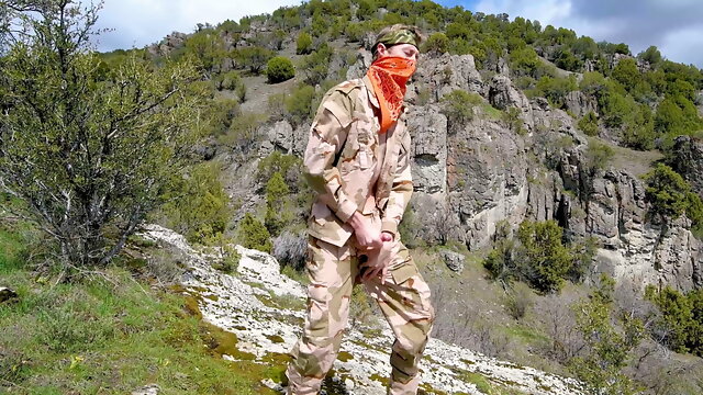 Soldier wanks himself on the mountainside on a warm spring day in the northern rocky mountains.