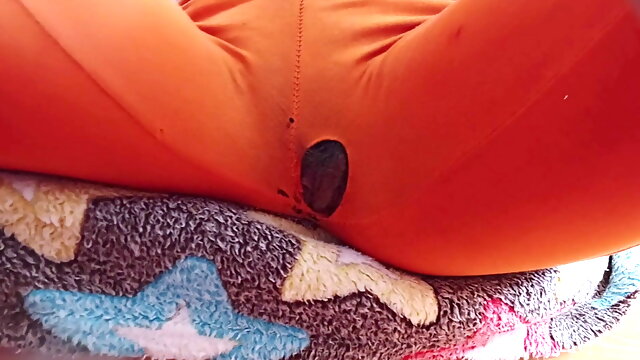 Indian girl working from home with hole in her pants. Under table view.