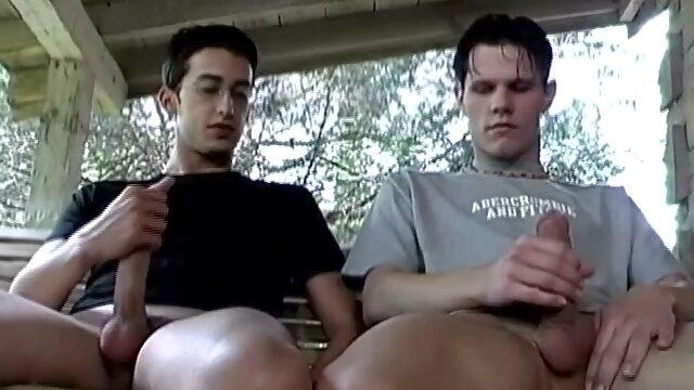 In this hot double handjob scene, Chris and Braden challenge each other to a handjob competition. Whoever cums first is the winner. Sitting side by side on the rocking couch for two, the two take out their big cocks and go ahead. to work.