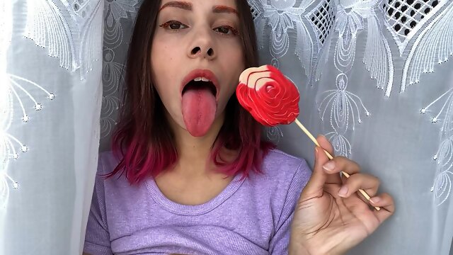 Naughty stepsister sucks a lollipop and show her long hot sexy tongue