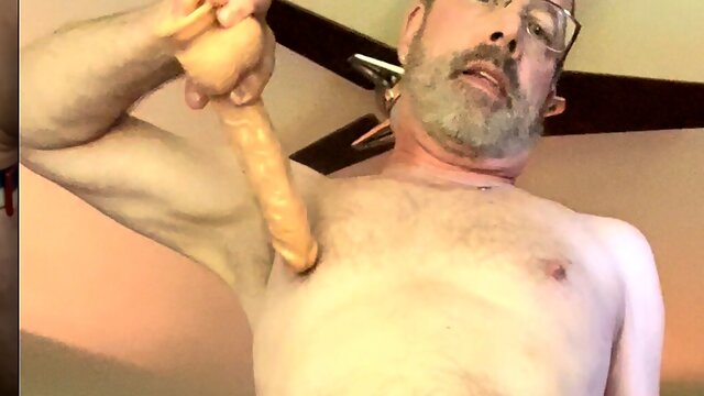 Kingkunga strips, fucks his hole with a large dildo, puts on cock ring, butt plug combo