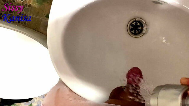 SisK peel off her penis and take a pee in sink