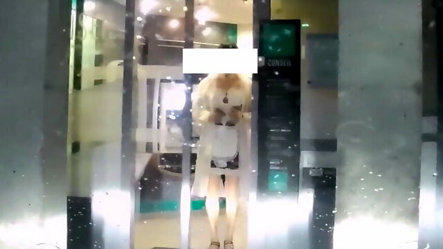 Maid dressed under transparent raincoat to cash dipenser