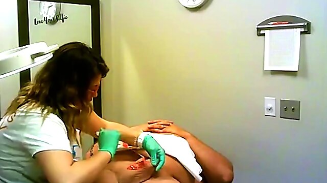 Brazilian waxing by a beautician with glasses