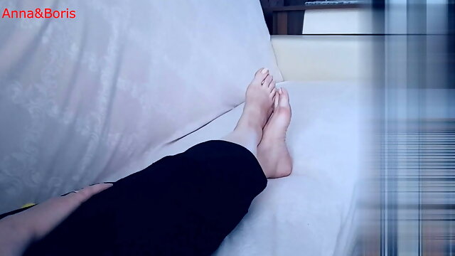 For comfort, Anna sits barefoot on the sofa - 1