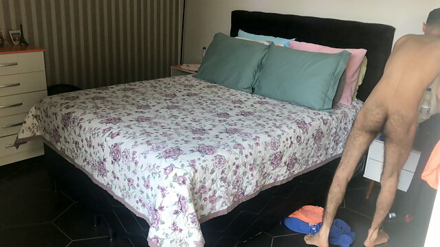 ENGAGED HUSBAND MAKING THE BED IN THE MORNING