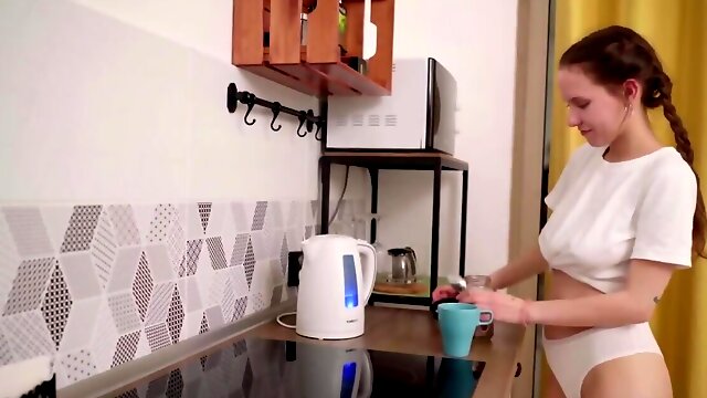 Russian cutie with natural tits masturbates in the kitchen