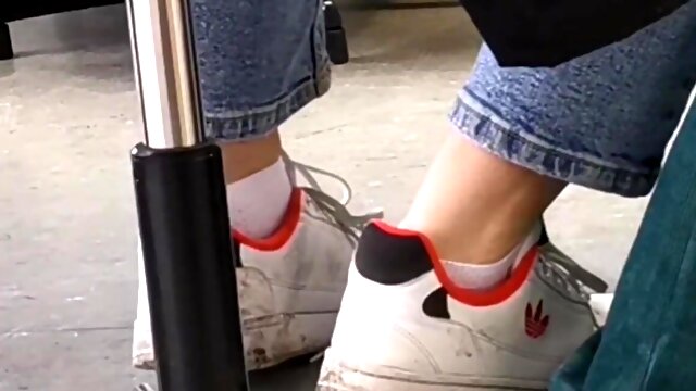 Candid feet in white ankle socks and sneakers