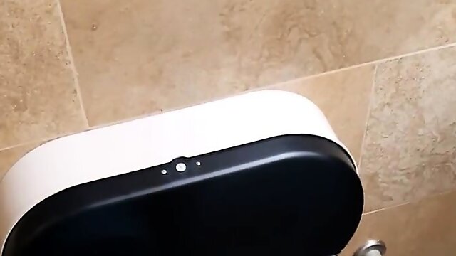 Spy cam in the bathroom catches a redhead sitting on the to