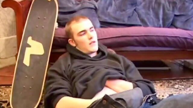 Back from skateboarding, Christian Wilde puts a hard cock through his pants and pulls it out. Some stroking with both hands ends up splattering cum on his chest.