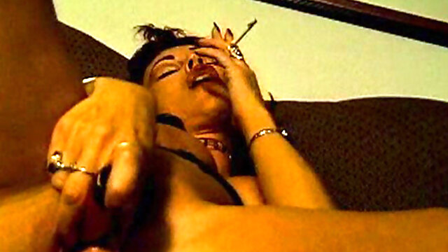 Smoking brunette enjoys solo masturbation