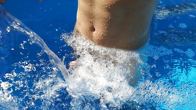 German Guy in the swimming pool enjoying the Waterfall