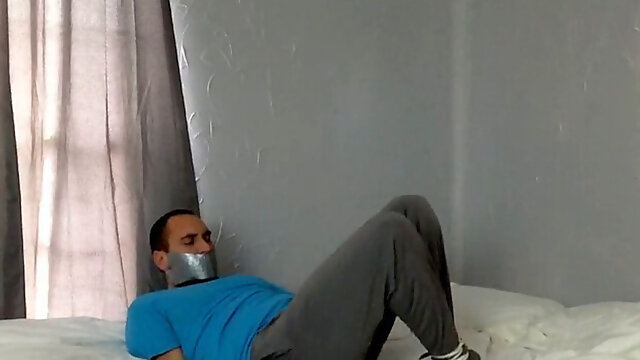 Frogtied and Tapegagged in sofa