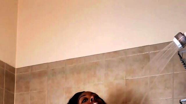 Masked black stud fucking a busty ebony milf in the shower