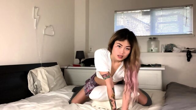 Horny Asian girl humping pillows and playing with sex toys