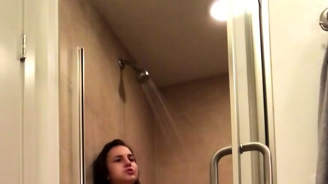 Horny brunette teen fingering her needy cunt in the shower