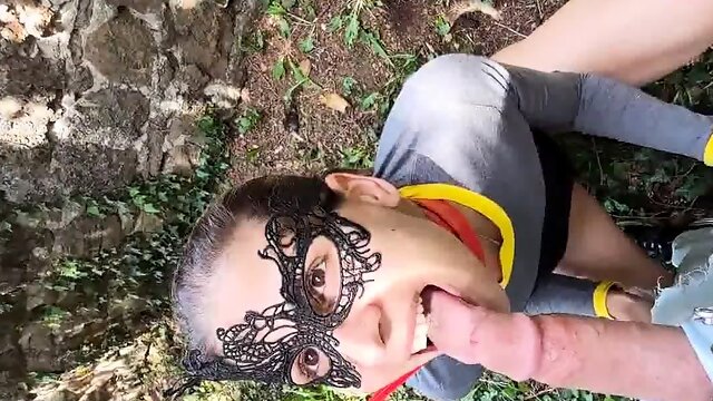 Masked teen on a leash worships a POV cock in the outdoors