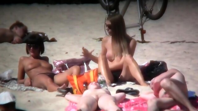 Nudist beach voyeur spying on a busty milf and a cute teen