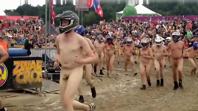 Wild folks wearing a helmet run naked on a cross track