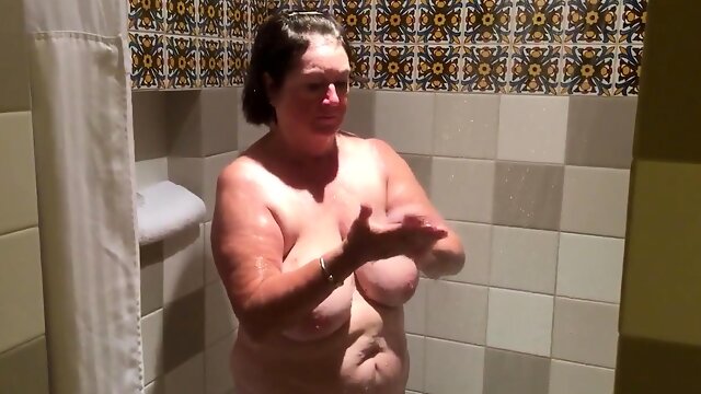 Chubby brunette granny flaunts her sexy body in the shower