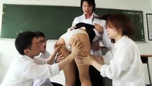 Busty Asian teacher enjoys a gang of cocks in the classroom