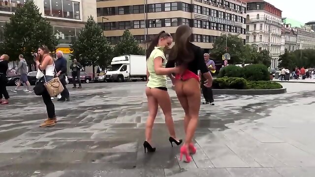 Two attractive European babes expose themselves in public