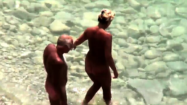 Handjob given by mature wife on public beach