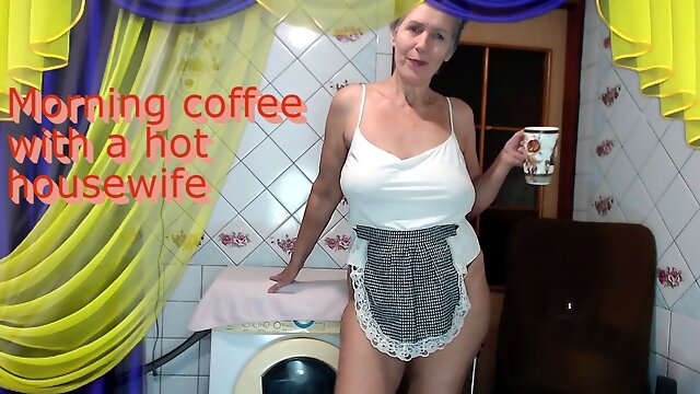 Morning coffee with a cheerful hot housewife chatting with fans over a cup of coffee while sitting on a washing machine.