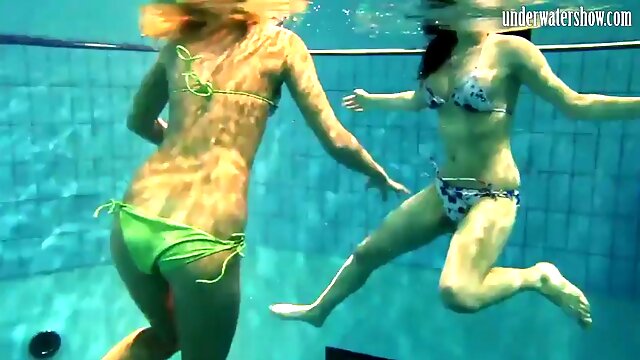 Girls Andrea and Monica undress each other underwater