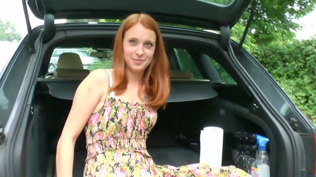 Yummy ginger girlfriend is masturbating her whorish pussy in the trunk