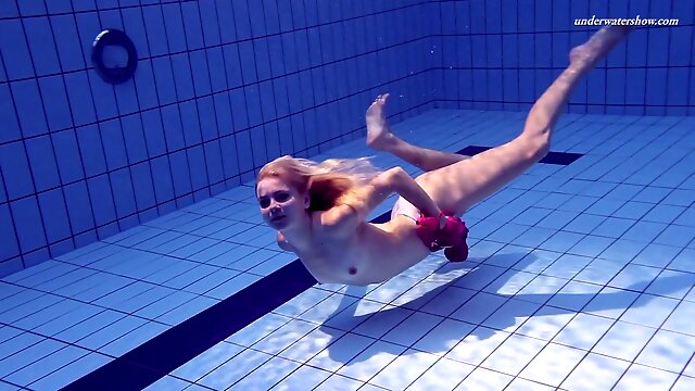 Sport swimming babe Elena Proklova is stripping under the water