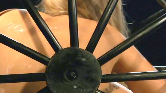 Cute blonde in the cage is punished by perverted master